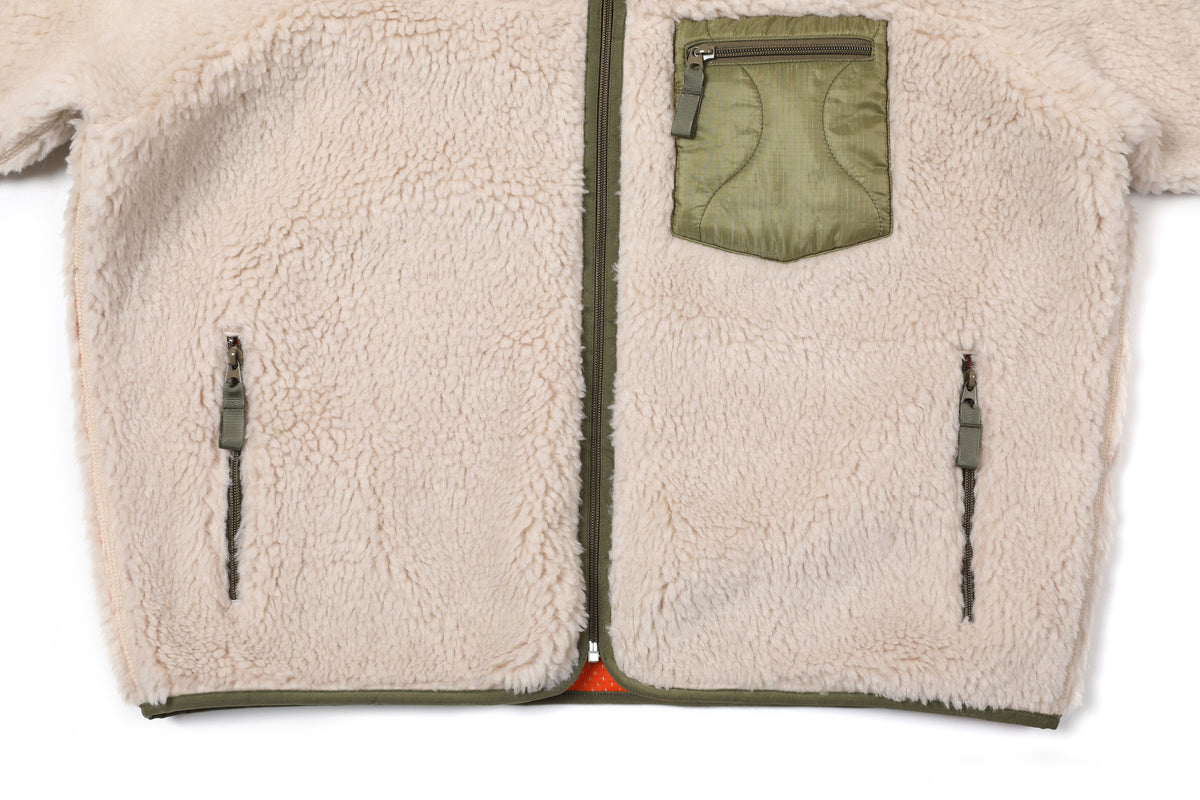 Fleece Jacket — front zip pockets and hem detail